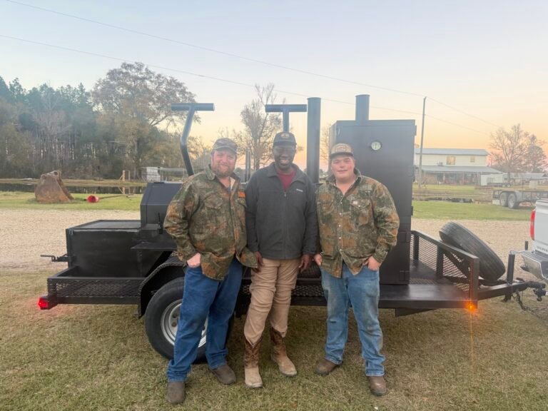 Mr. Fred with Matthew and Adam Lea of Lea's Welding and Fabrication beside the completed custom BBQ smoker